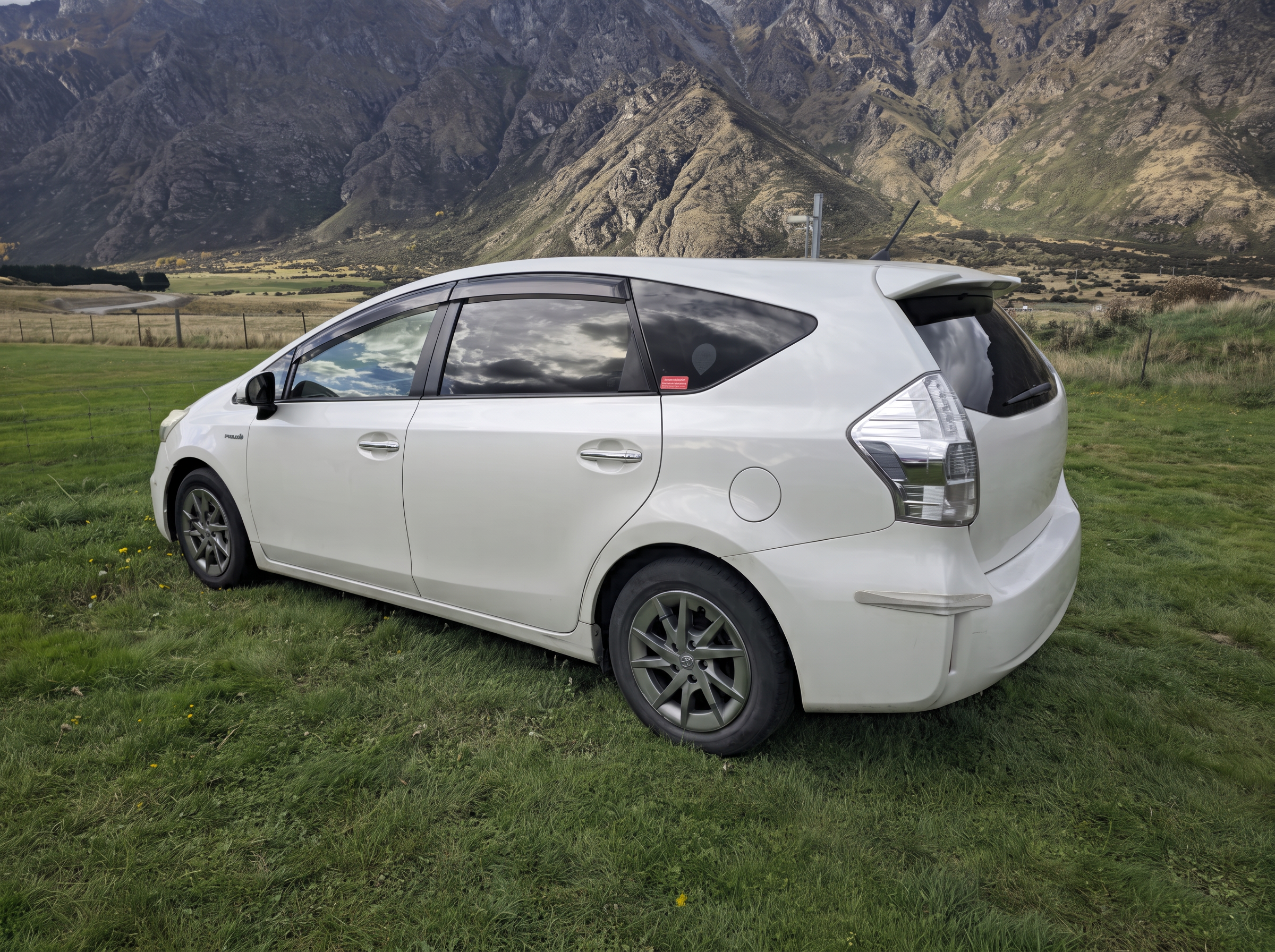 White Toyota Prius hybrid car in the mountains